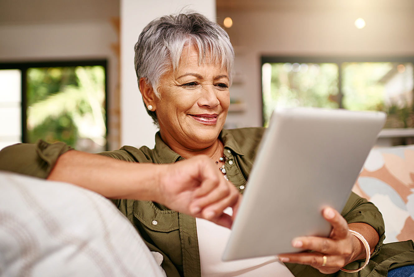 Woman at home using tablet.